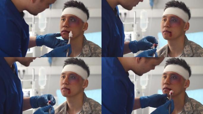 军队医院医生清洗亚洲士兵脸上伤口的特写