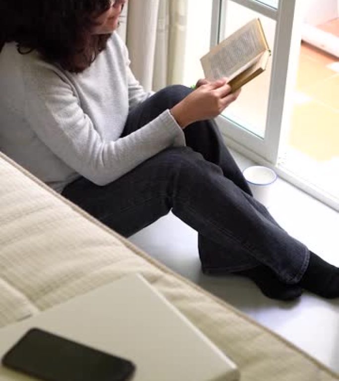 垂直视频: 女人停止使用技术冷静地读书