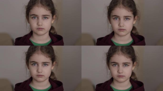 肖像悲伤的小女孩看着相机。思考好奇心的孩子在室内看着相机特写。沮丧的脸眼睛严肃沉思的孩子。严重的学生