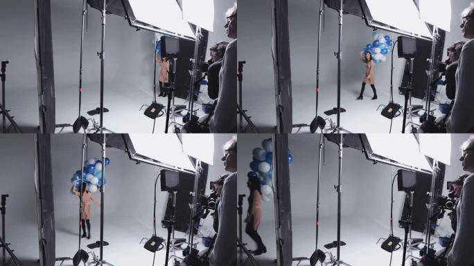 工作室拍摄摄影师用一堆气球拍摄女孩