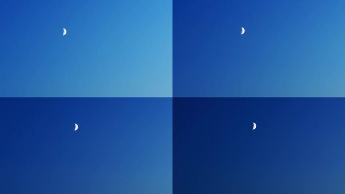 晚上在晴朗的蓝天背景上移动的新月半月形