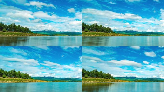 蓝天、移动云和反射的湖的低角度视图，Timelaspe视频