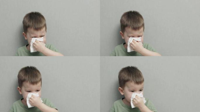 肖像儿童男孩吹鼻子，用孤立的餐巾纸擦拭。特写视图