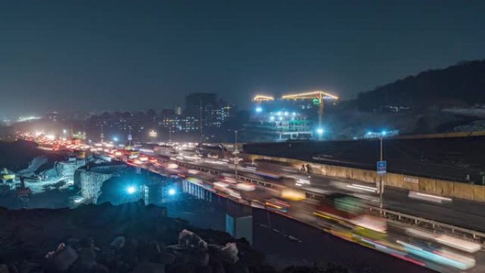 沿边高速公路的道路和建筑施工现场，繁忙的夜间交通时间在印度马哈拉施特拉邦的印度城市的国道上流逝