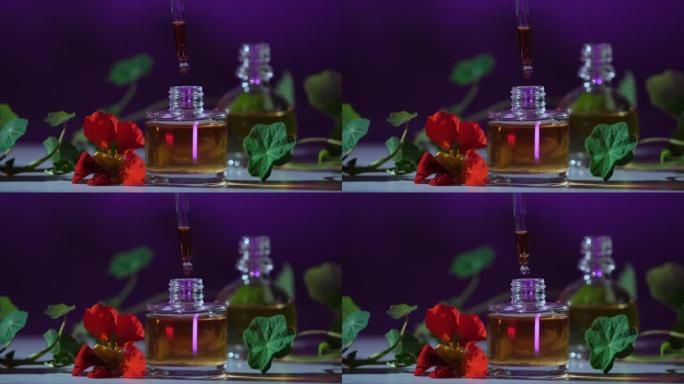 香水。精油产品。从化妆品移液器滴落到装有香水的玻璃瓶。皮肤和身体护理。芳香草本植物和花卉液体。美容和