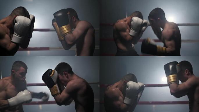 两名专业的年轻肌肉光着膀子的男性拳击手在拳击场上打架的电影慢动作镜头。高质量全高清镜头