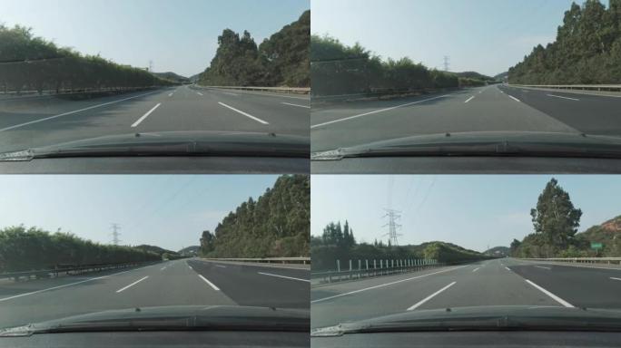行驶在高速公路上，两边都是郁郁葱葱的绿色