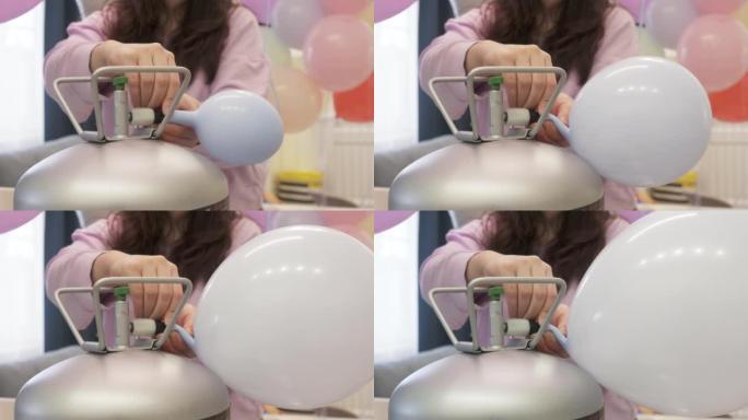 女人用氦气罐吹起气球来装饰家庭派对，彩色气球用于生日婚礼圣诞派对活动装饰。