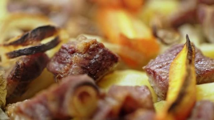 美味的热土豆和肉的特写镜头在模糊的烟熏背景上在布拉柴维尔的烧烤炉上煮熟