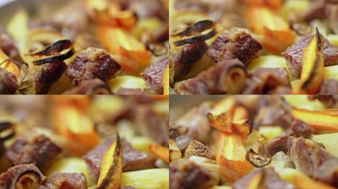 美味的热土豆和肉的特写镜头在模糊的烟熏背景上在布拉柴维尔的烧烤炉上煮熟