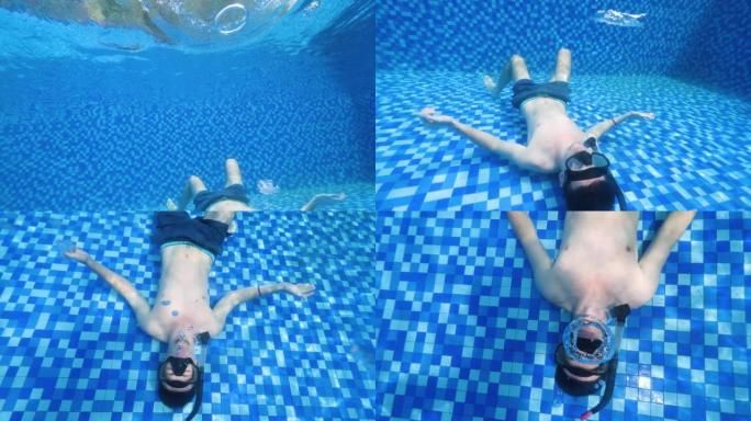 一个男人躺在游泳池底部制作泡泡环的水下场景。