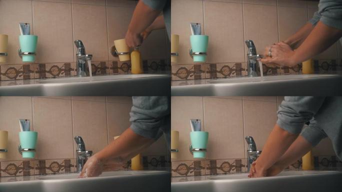 女人在水龙头下用肥皂洗手