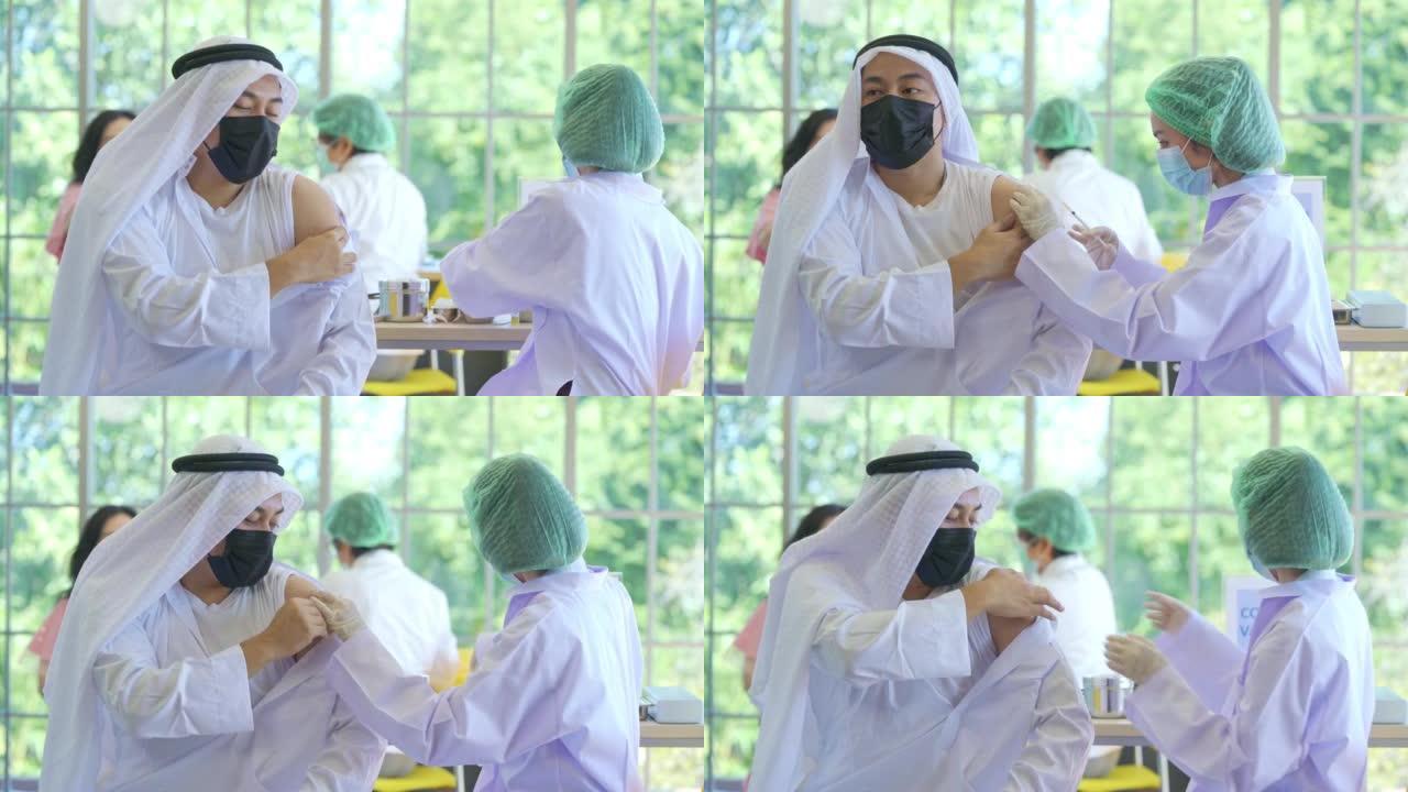 医生在医院给一名中东阿拉伯男子注射新冠病毒疫苗，以预防欧米克隆冠状病毒的爆发