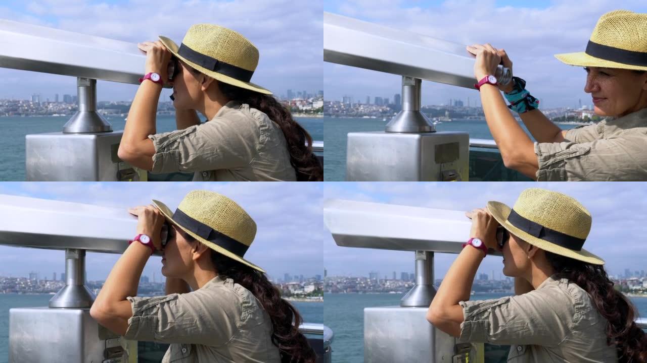 时尚的女性游客通过双目望远镜观察城市天际线。
