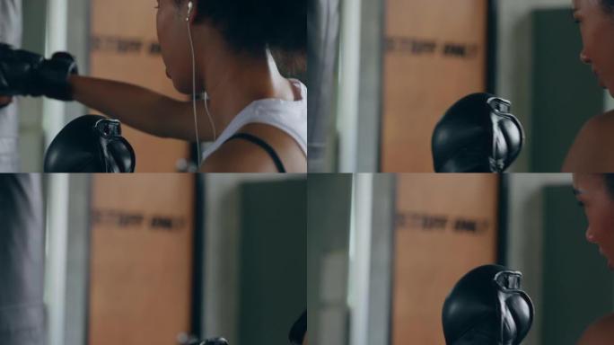 4k健康的非洲妇女在健身房做拳击运动时听耳机音乐。