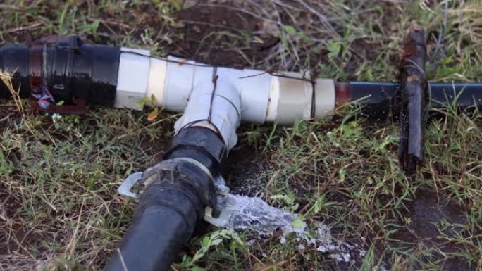 三根水管用于农田里从农田漏水的管道滴落的水。源源不断的水流来自管道。或者水从铺设在地面上的漏水管道中