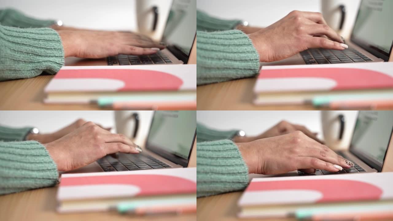 在现代笔记本电脑上打字的女性手的特写做笔记。女人在键盘上写作和工作