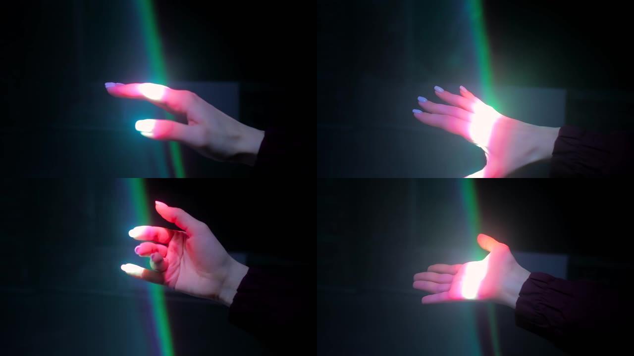 女人在彩色激光光线下移动手-特写-视觉概念