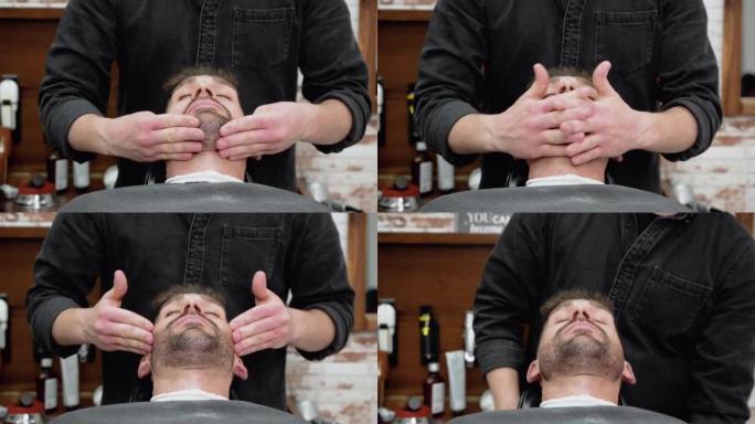 理发师在专业理发店给他理发后，在年轻人的胡须上按摩和擦油。高质量4k镜头