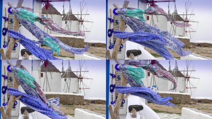希腊米科诺斯岛的传统风车和在风中飘扬的头巾