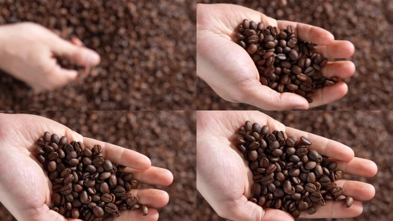双手舀起烤咖啡豆。新鲜烘烤的芳香浓郁的深棕色咖啡豆在一大堆新鲜咖啡豆上sc起。慢动作。