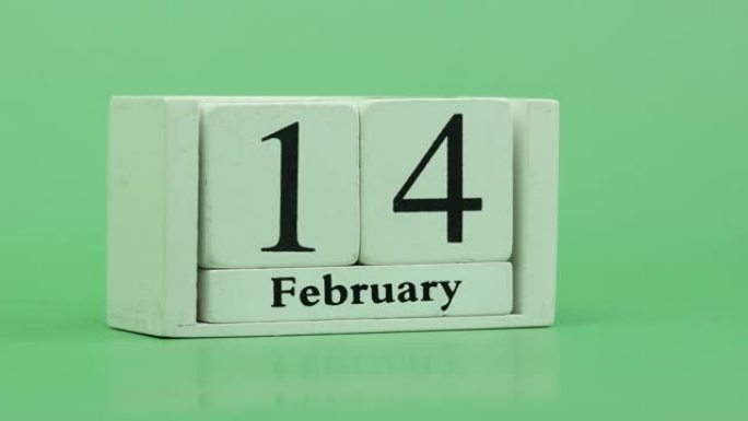 2月月份日历4k停止运动通过手工木制日历在一个月内快速的时间节奏，日期月份和日期放在木桌上