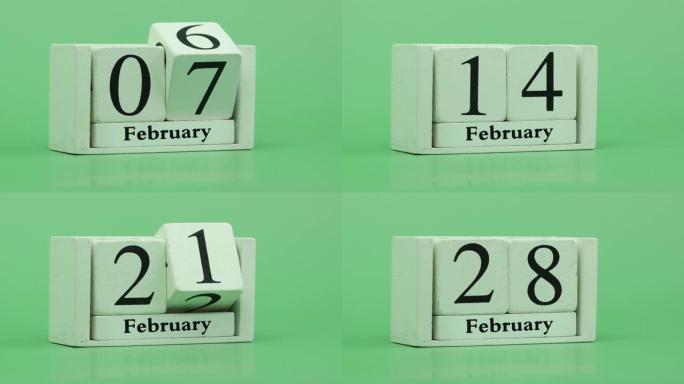 2月月份日历4k停止运动通过手工木制日历在一个月内快速的时间节奏，日期月份和日期放在木桌上