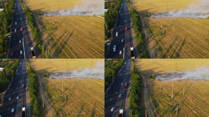 红色救火车直奔农田大火的震中，高速公路附近有很多汽车
