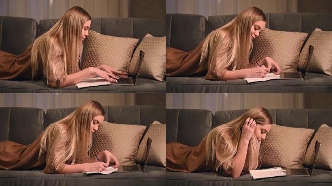 一个十几岁的女孩正在用笔记本电脑在家上学，在笔记本上做笔记。关于沙发、远程学习和工作的研究