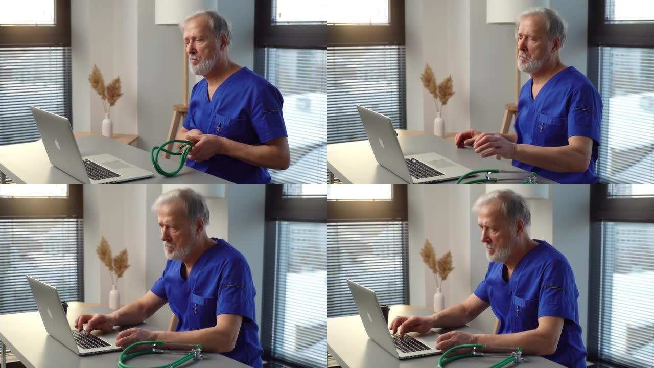 疲惫的成熟男性医生坐在桌旁，开始在笔记本电脑上打字。