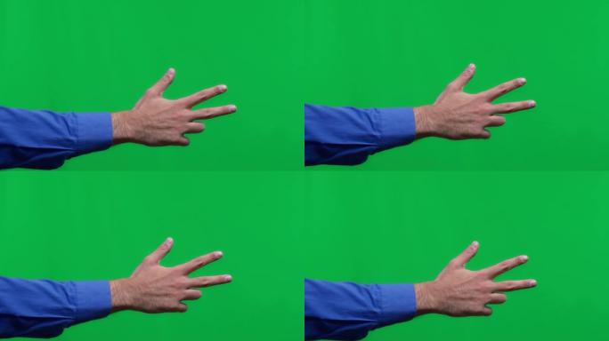 男性手在孤立的绿色背景上展示三个手指