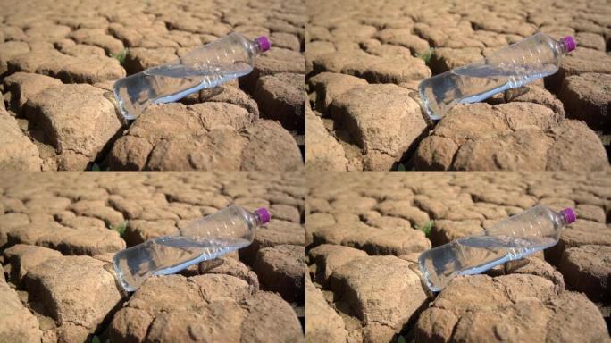 在干旱环境灾害概念下，用干净的淡水在沙漠中的沙子中装瓶。全球变暖。