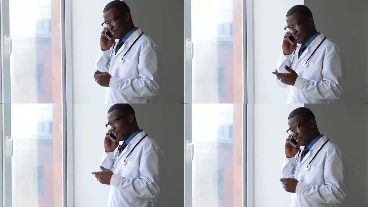 年轻的男医生在现代诊所spba的工作日内通过电话交谈
