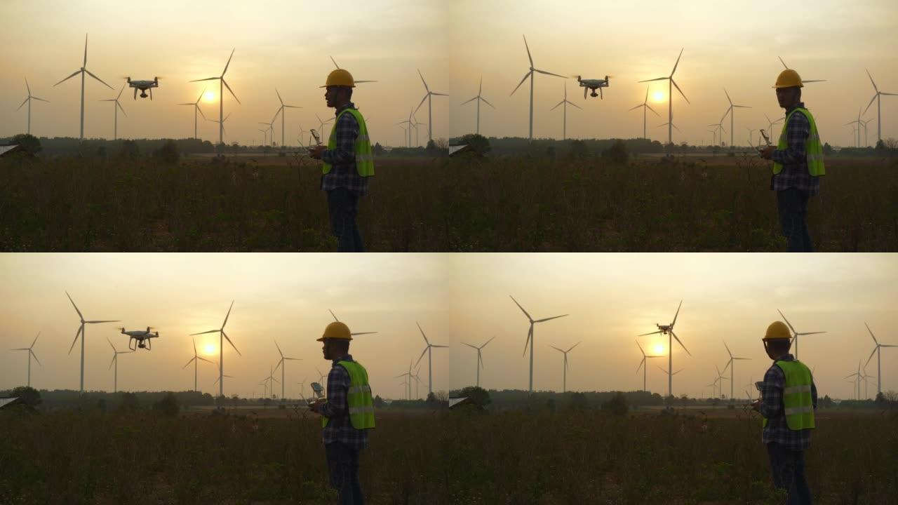 日落时，一名男子在田野里控制着一架无人机。