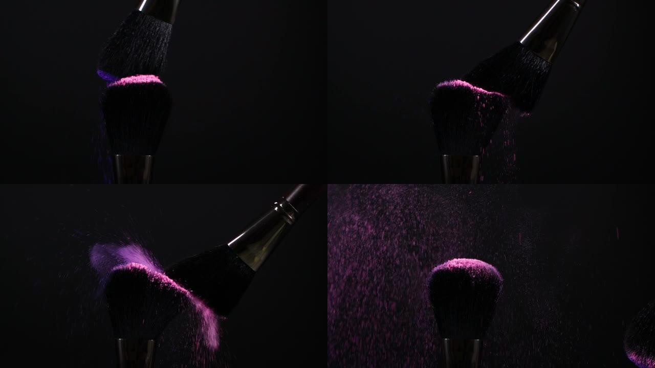 黑色上有粉色和紫色飞行眼影粉末颗粒的化妆刷