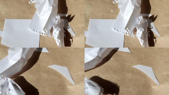 4k视频，棕色牛皮纸背景上皱巴巴的白色床单飞离风的微距摄影