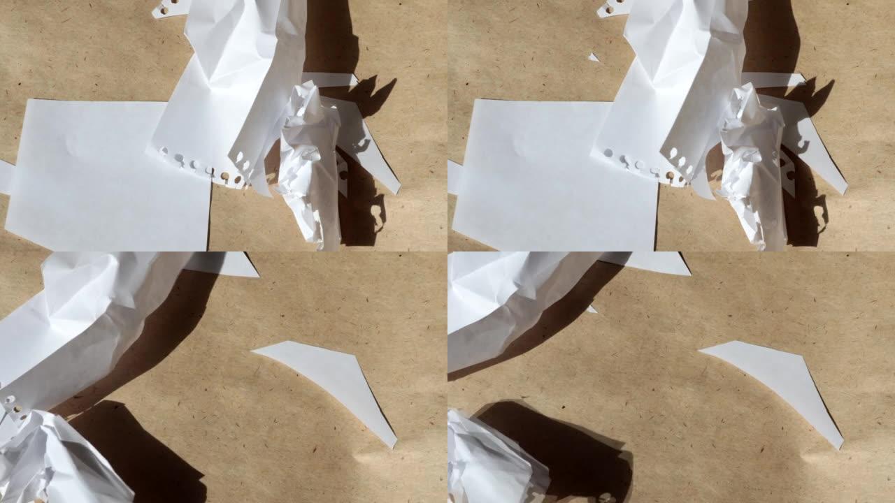 4k视频，棕色牛皮纸背景上皱巴巴的白色床单飞离风的微距摄影