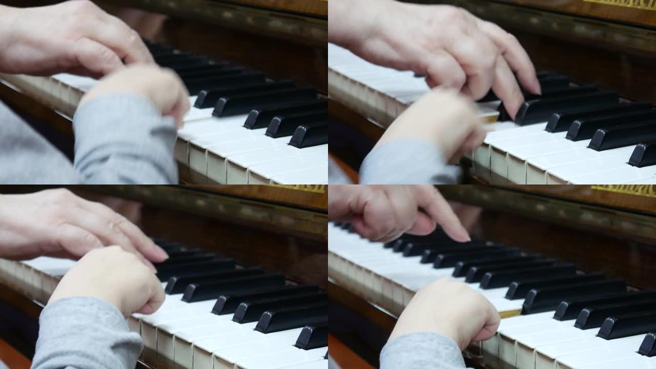 一名儿童和一名老妇一起弹钢琴的手的特写