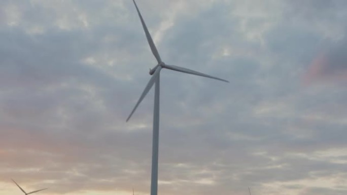 旋转的风力涡轮机下闪耀的日落天空，风力发电技术