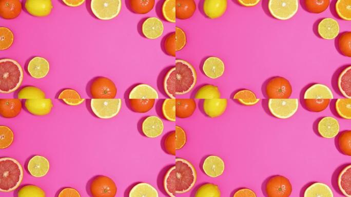 新鲜成熟的切片柑橘类水果在充满活力的粉红色主题上制作框架边框。停止运动平铺