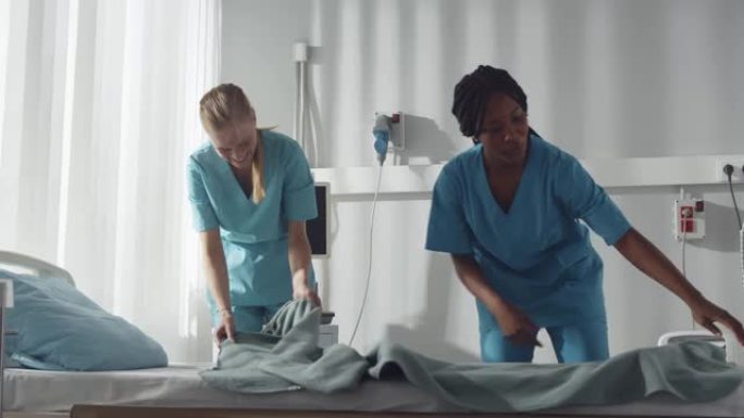 多样化的年轻护士在医院病房里铺床和打扫卫生