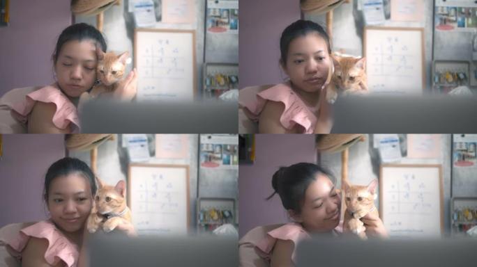 亚洲女人在新家拥抱和亲吻小猫。收养流浪猫的概念有一个爱并能照顾他们的新主人。