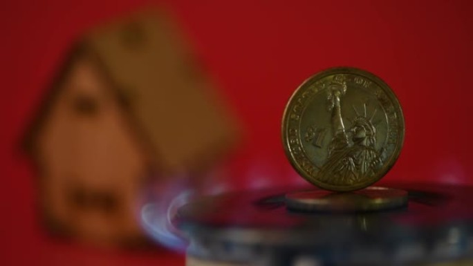一枚一美元硬币站在一个热气腾腾的煤气炉上