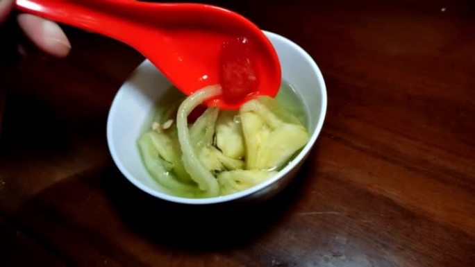 水果冰放在一个小碗里，当打破快餐时，瓜果冰和糖浆