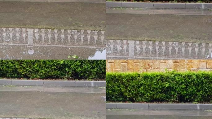 4k视频，雨后栏杆在湿沥青上的水坑中的水面反射。抽象自然背景