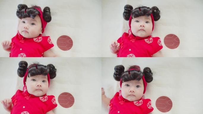 肖像可爱亚洲新生女婴中国传统红色服装，节日概念春节