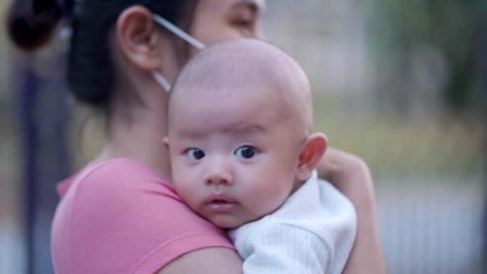 可爱，新生的亚洲男婴。家庭幸福，亚洲年轻的母亲带着爱去照顾。小无辜的新生婴儿在生命的第一天。母亲节概