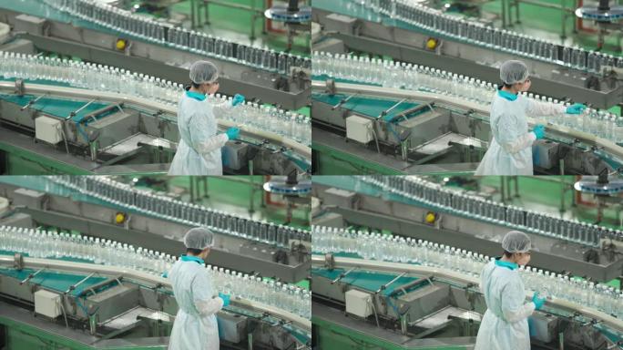 亚洲华人水厂生产线女工，携带个人防护用品，日常检查水瓶工作