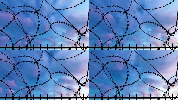 日落动画上的监狱边界围栏循环。明亮的太阳与铁丝网剪影自由。