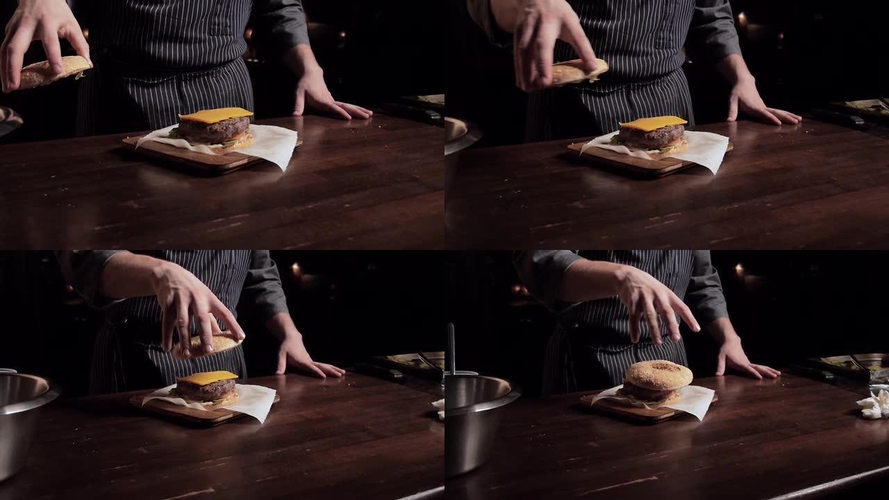 厨师端来一个小圆面包放在汉堡上，松开它，牵着他的手往前走